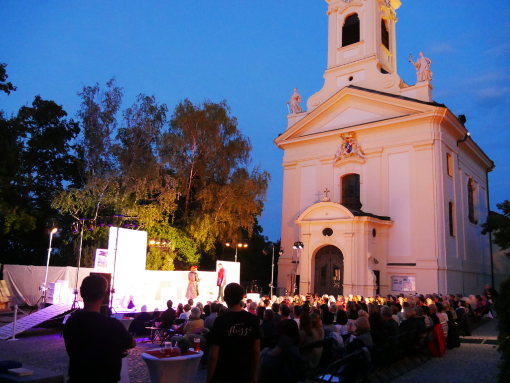 FJM22 - Rodauner Kirchenplatz. Bühne des Rodauner-Theater-Sommers vor der Bergkirche mit Publikum